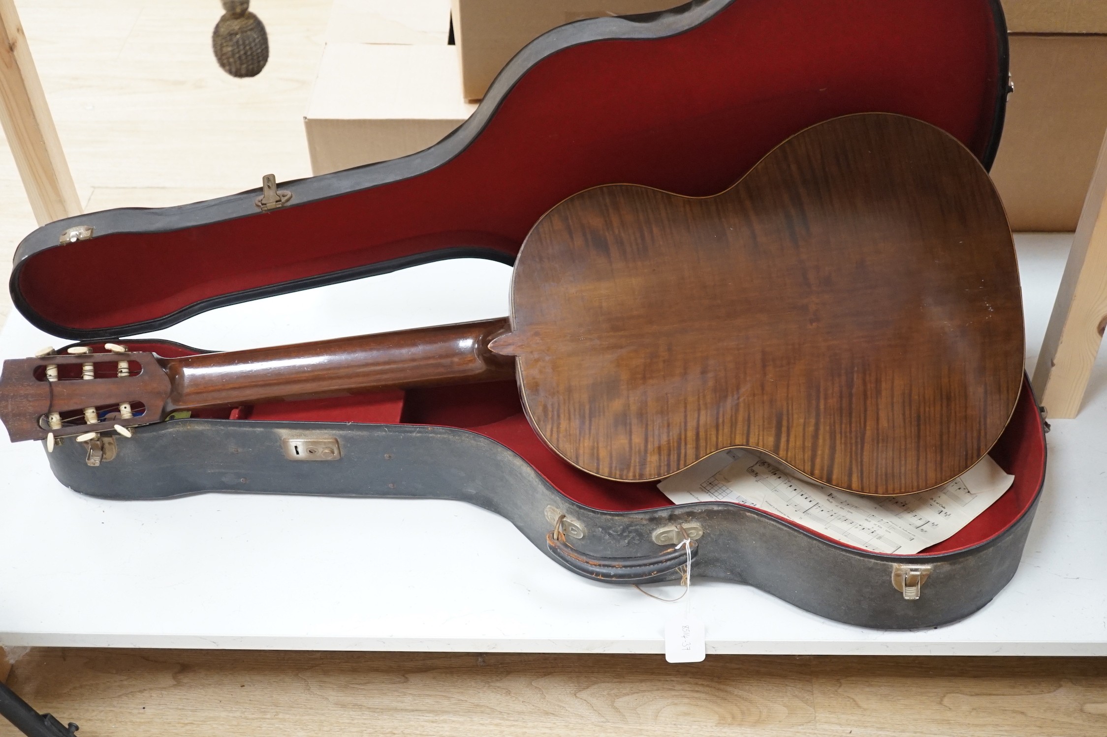 A Harald Petersen classical concert guitar, paper label interior, with hard case. Length of back 49cm excluding button